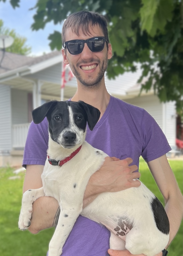 A man holding a puppy